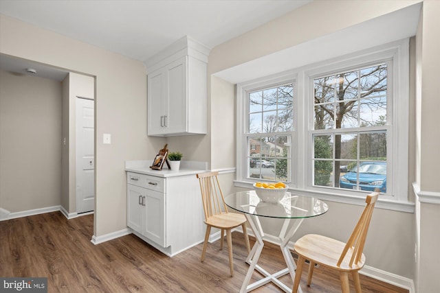 dining room featuring baseboards and wood finished floors