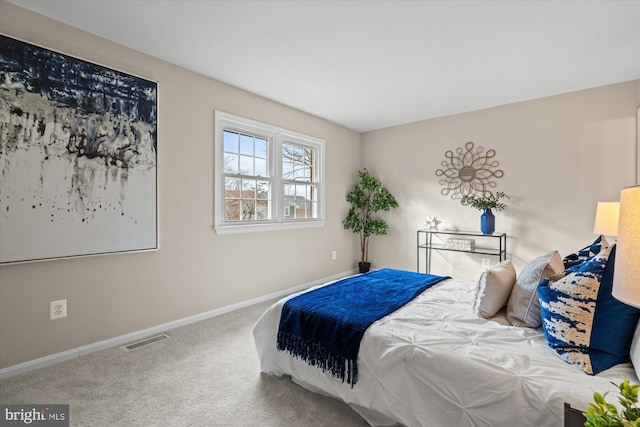 carpeted bedroom with visible vents and baseboards