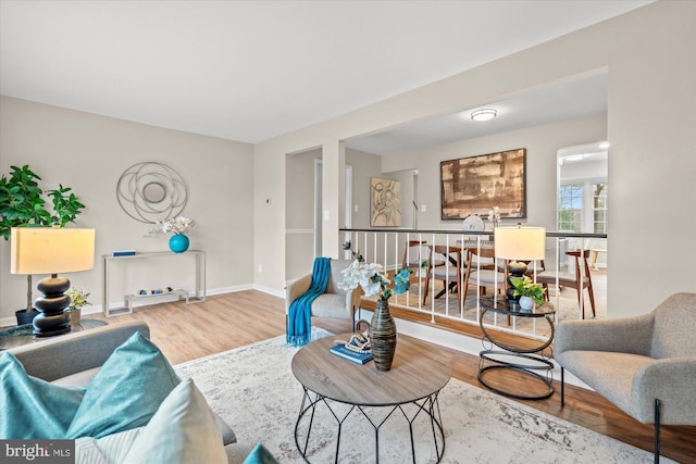 living area featuring baseboards and wood finished floors