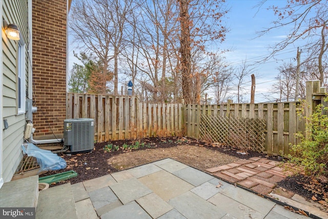 view of patio / terrace with a fenced backyard and central air condition unit