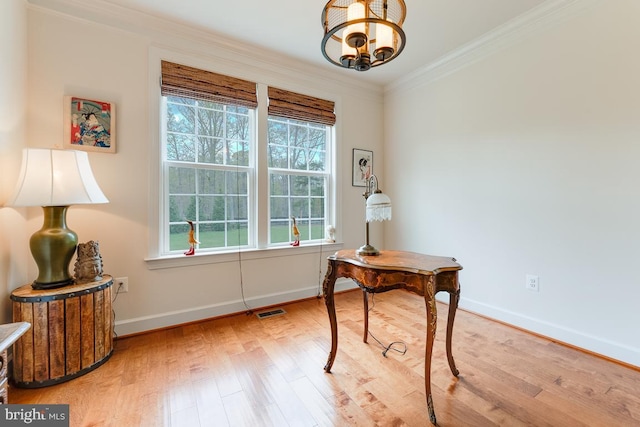 office area featuring crown molding, a notable chandelier, visible vents, wood finished floors, and baseboards