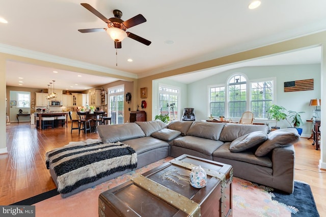 living area with ceiling fan, recessed lighting, baseboards, light wood-style floors, and ornamental molding