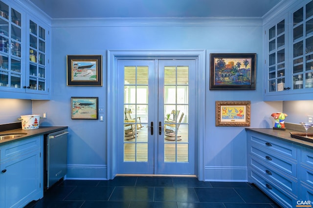 entryway featuring baseboards, dark tile patterned flooring, crown molding, french doors, and a sink