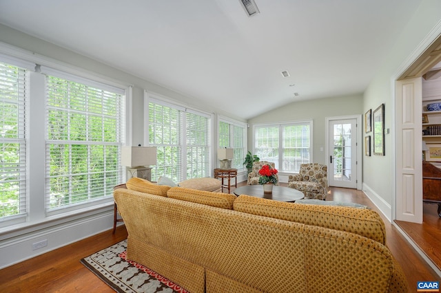 sunroom with visible vents, vaulted ceiling, and a wealth of natural light