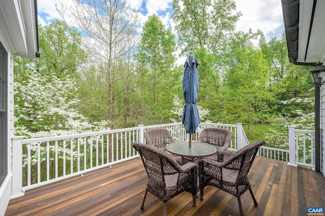 wooden deck featuring outdoor dining space