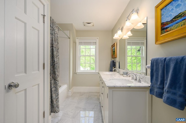 bathroom with shower / bath combination with curtain, a wealth of natural light, vanity, and baseboards