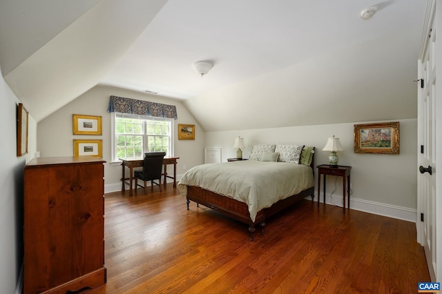 bedroom featuring dark wood-style floors, lofted ceiling, and baseboards