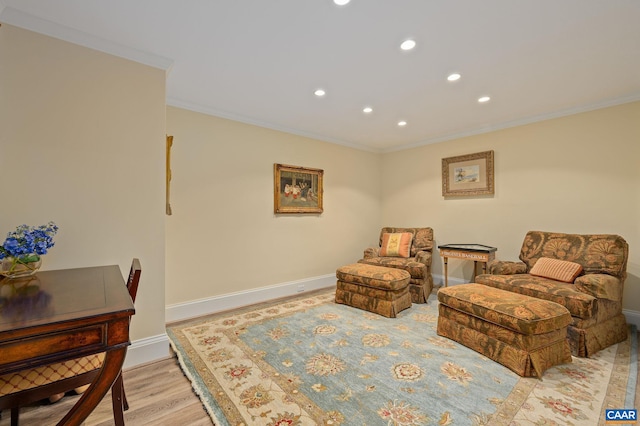 living area featuring ornamental molding, recessed lighting, light wood finished floors, and baseboards