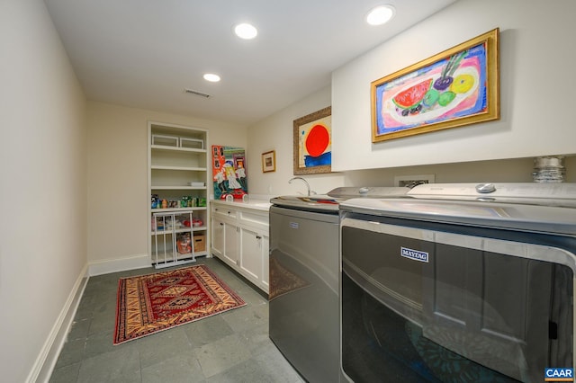 laundry area featuring recessed lighting, separate washer and dryer, visible vents, baseboards, and cabinet space