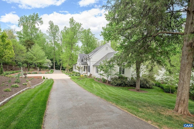 exterior space with driveway and a lawn