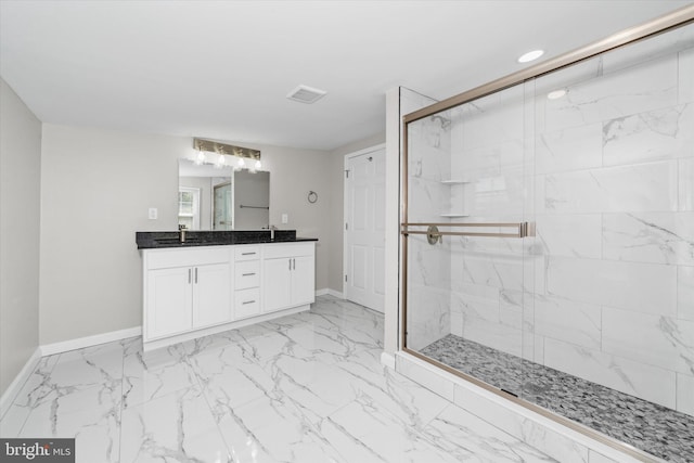 bathroom featuring a marble finish shower, visible vents, baseboards, and a sink