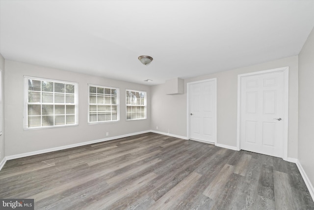 unfurnished bedroom with baseboards and wood finished floors