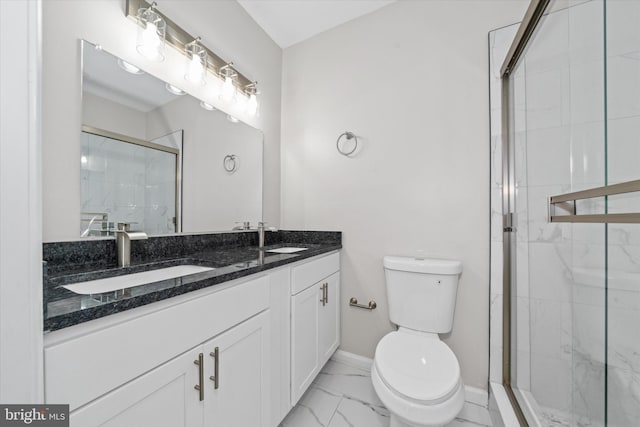 bathroom with marble finish floor, toilet, a shower stall, and a sink