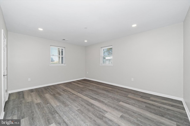 unfurnished room with recessed lighting, baseboards, and wood finished floors