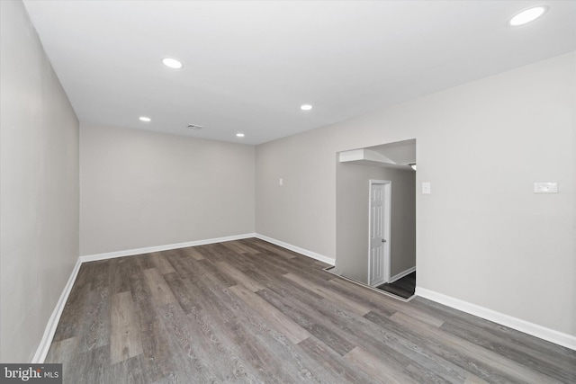 empty room with recessed lighting, visible vents, baseboards, and wood finished floors