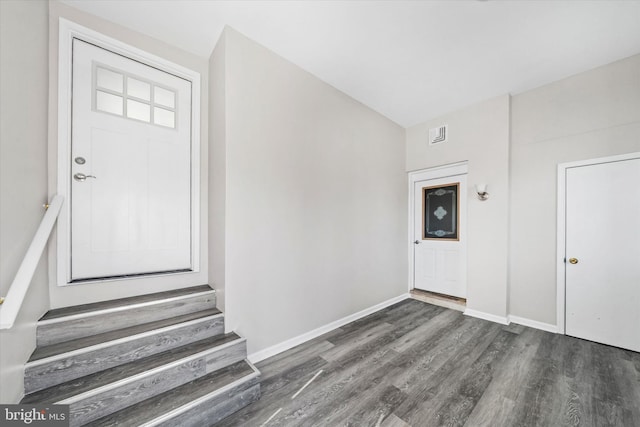 foyer with stairway, wood finished floors, and baseboards