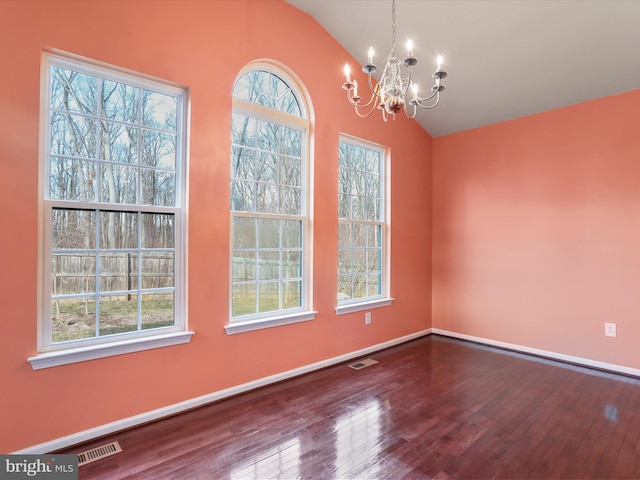 unfurnished dining area with lofted ceiling, visible vents, and hardwood / wood-style floors