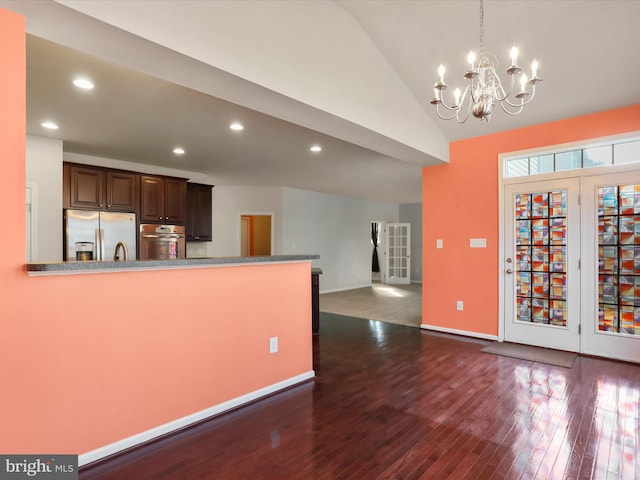 kitchen with dark brown cabinetry, appliances with stainless steel finishes, dark wood-style flooring, vaulted ceiling, and recessed lighting