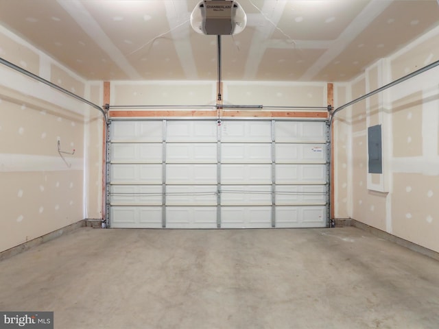 garage with electric panel, baseboards, and a garage door opener