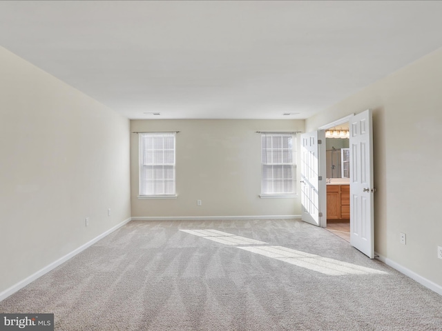 empty room with light carpet and baseboards