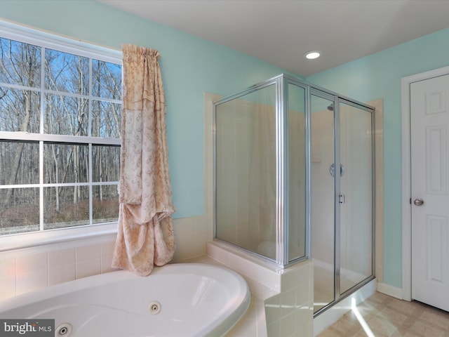 full bath featuring a stall shower, a jetted tub, and recessed lighting