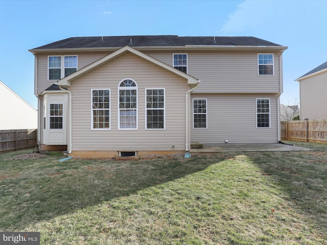 back of property with a lawn, a patio area, and a fenced backyard