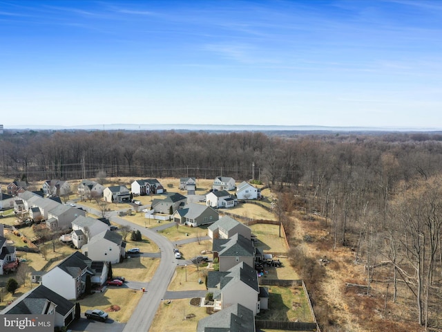 birds eye view of property with a forest view and a residential view