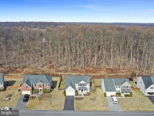 birds eye view of property with a residential view and a view of trees