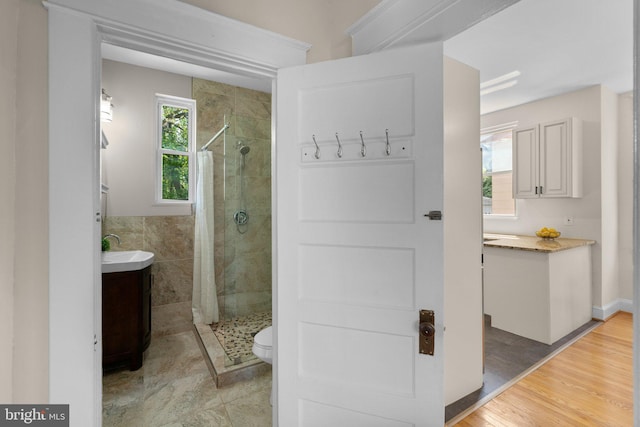 full bathroom with vanity, a stall shower, and toilet