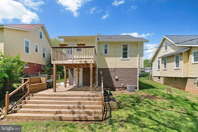 rear view of property with a yard, central AC, and a wooden deck