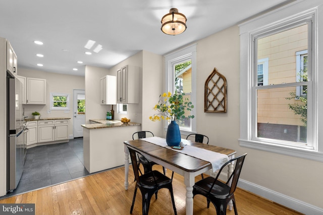 dining area featuring baseboards, recessed lighting, and wood finished floors