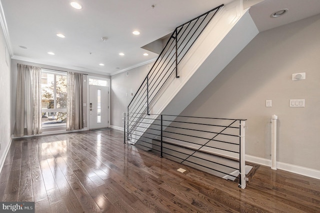 entryway featuring baseboards, wood finished floors, stairs, crown molding, and recessed lighting