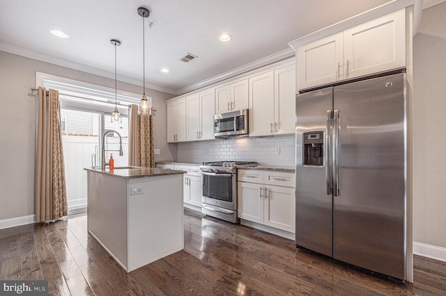 kitchen with appliances with stainless steel finishes, crown molding, decorative backsplash, and dark wood-style floors