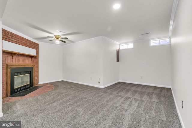 unfurnished living room featuring a ceiling fan, baseboards, carpet floors, a fireplace, and ornamental molding