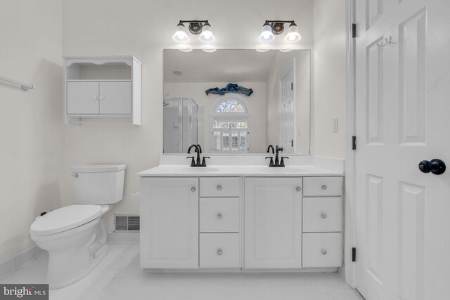 bathroom featuring a sink, visible vents, toilet, and a stall shower