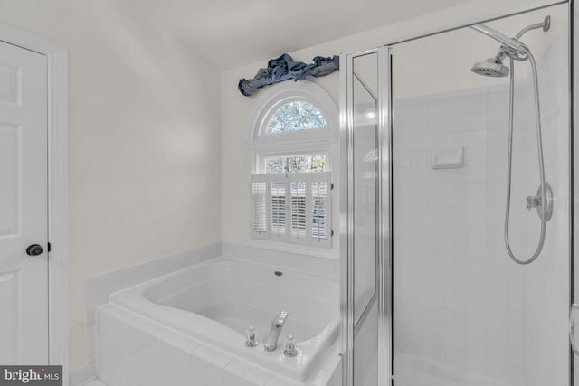 full bath with a stall shower and a garden tub