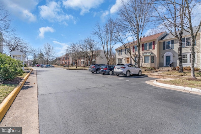 view of road with curbs, a residential view, and sidewalks