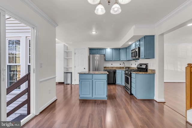 kitchen with blue cabinets, a kitchen island, appliances with stainless steel finishes, and dark wood finished floors