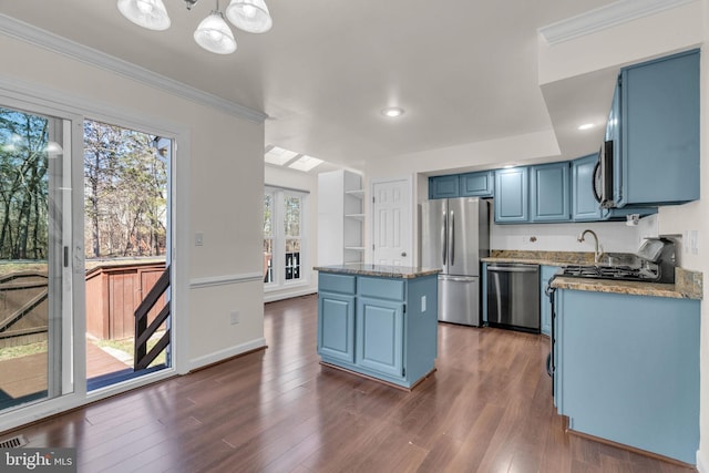kitchen featuring blue cabinets, dark wood-type flooring, appliances with stainless steel finishes, and a center island