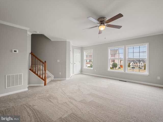 unfurnished living room featuring visible vents, crown molding, stairway, and baseboards