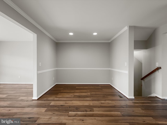 empty room featuring recessed lighting, baseboards, wood finished floors, and ornamental molding