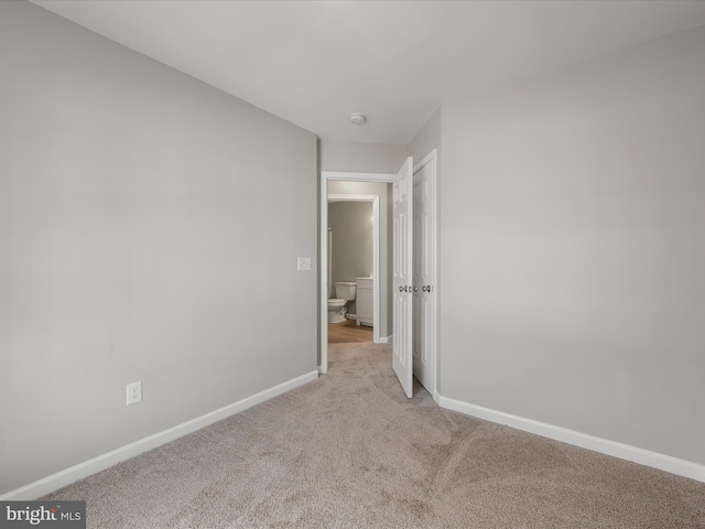 unfurnished bedroom with carpet floors and baseboards