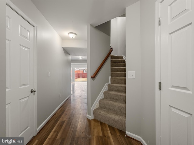 stairway featuring wood finished floors and baseboards