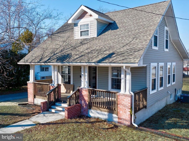 view of front of property with covered porch and roof with shingles