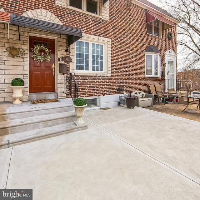 doorway to property with brick siding