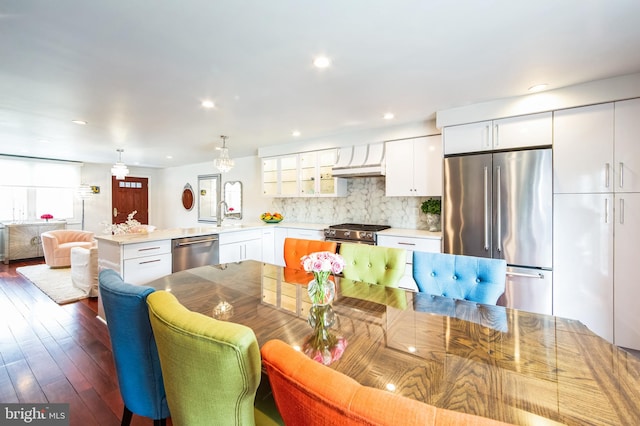 dining space with recessed lighting and wood-type flooring