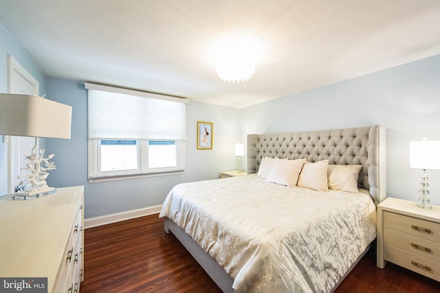 bedroom with dark wood-style floors and baseboards