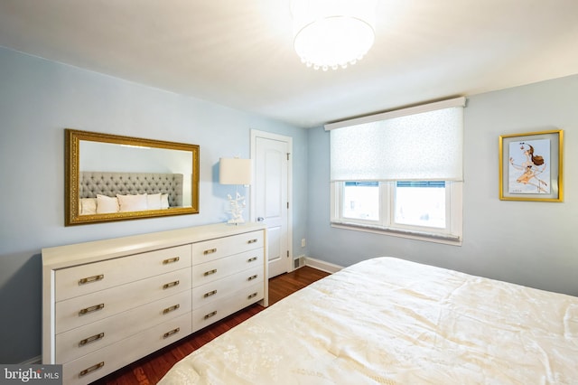 bedroom featuring visible vents and dark wood-type flooring