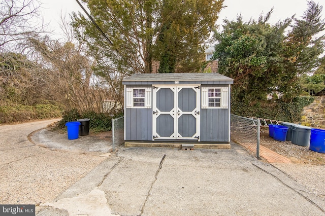 view of shed with fence