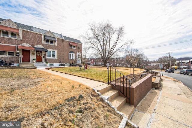 view of home's community featuring a lawn and a residential view